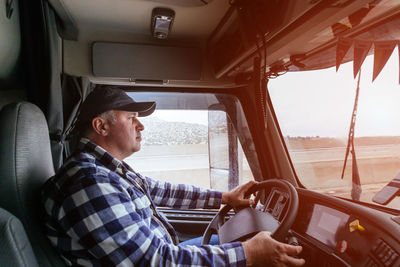 Portrait of man sitting in car