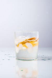 Close-up of beer glass on table against white background