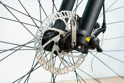 Low angle view of bicycle wheel against sky