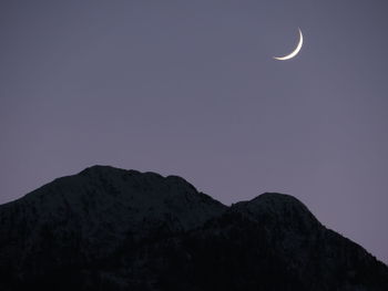 Low angle view of moon in sky at night