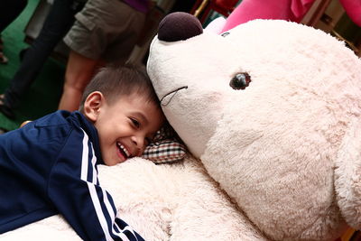 Smiling boy with teddy bear