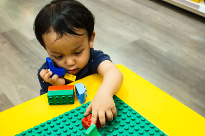 High angle view of baby boy playing with toys at home