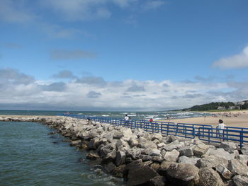 People on beach against sky