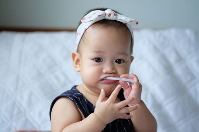 Portrait of cute baby girl looking away