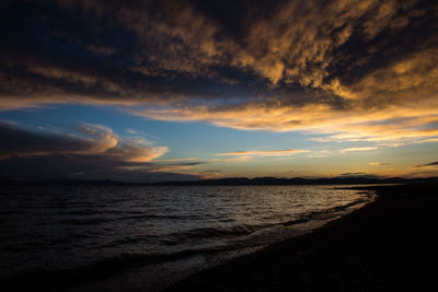 Scenic view of beach against sky during sunset