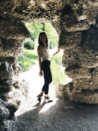 Full length of woman standing on rock