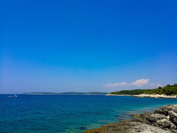 Scenic view of sea against clear blue sky