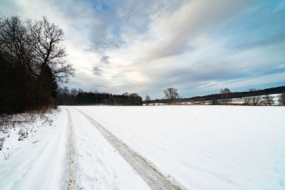 Snow covered field against sky