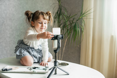 Portrait of a girl looking through camera