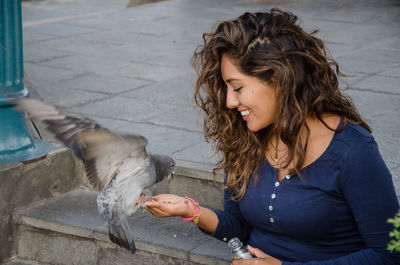 Young woman eating birds