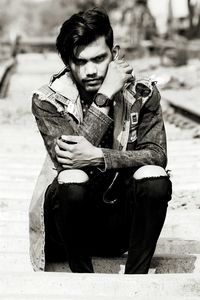 Portrait of young man sitting outdoors