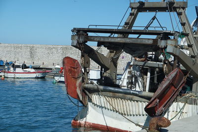 Ship at harbor against clear sky