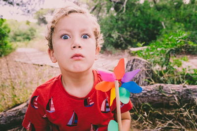 Portrait of boy holding pinwheel toy