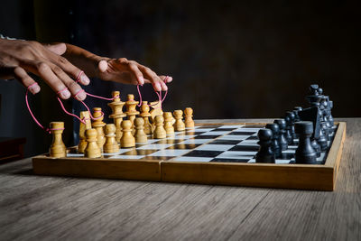 Low angle view of man playing on chess board