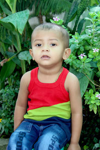 Little cute indian baby boy 2 year old sit at park alone, selective focus.