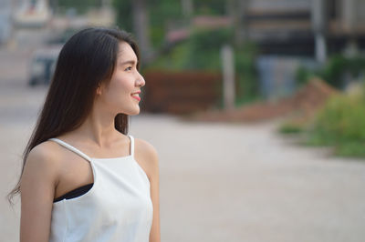 Portrait of a young woman looking away