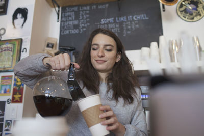 Young woman at store counter.