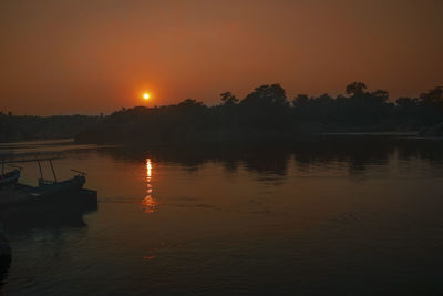 Scenic view of lake against sky during sunset