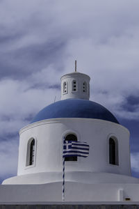 Santorini, greece, may 4, 2024. oia, oia, church of panagia akhistos hymn, roof with the greek flag