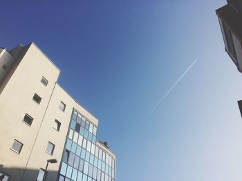 Low angle view of buildings against clear blue sky