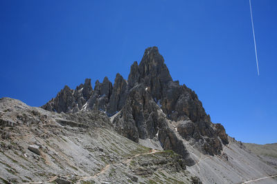 Low angle view of mountain against clear blue sky