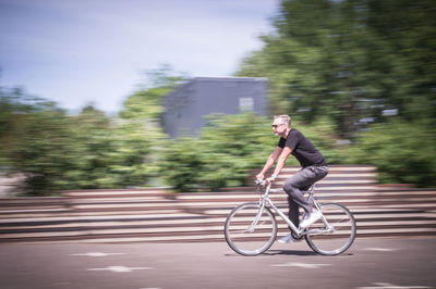 Man riding bicycle on road