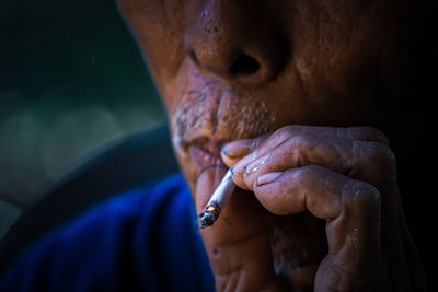 Close-up of man smoking cigarette