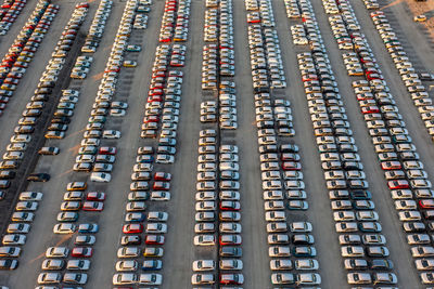 Aerial view of brand new cars at the logistics center, near the factory. car parking lot.