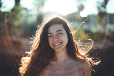 Smiling woman outdoors in sunny day