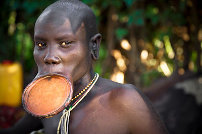 Close-up portrait of man looking away outdoors