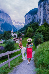 Rear view of women walking on mountain road