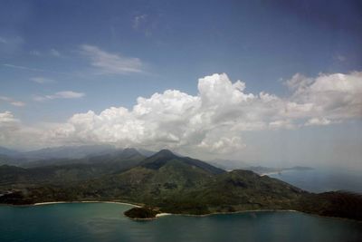 Scenic view of mountain range against cloudy sky