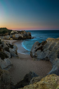 Scenic view of sea against clear sky at sunset