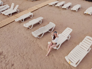 High angle view of woman lying on chair