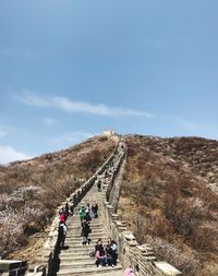 People walking on road against sky