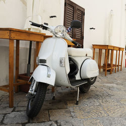 Motor scooter against white wall at home