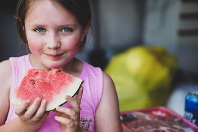 Portrait of smiling girl holding watermelon