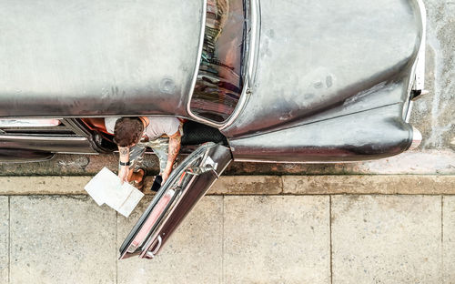 High angle view of man in car holding map