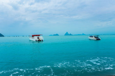 Boat sailing in sea against sky