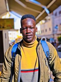 Portrait of man standing in city