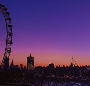 Silhouette of buildings against sky at sunset