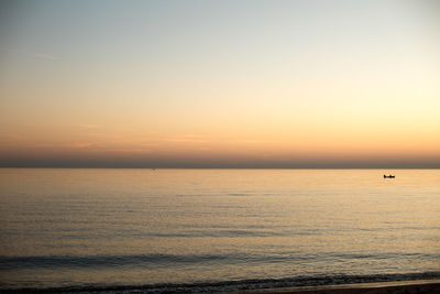 Scenic view of sea against orange sky