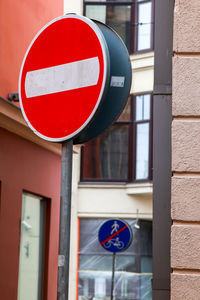 Road sign against built structure