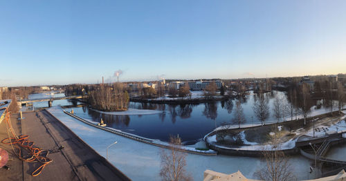 Panoramic view of river and buildings against clear sky