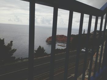 Scenic view of sea seen through balcony window