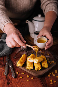 Midsection of man preparing food on table