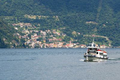 Nautical vessel on sea by buildings in city