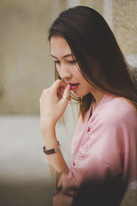 Multiple image of woman looking down while standing outdoors