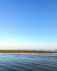 Scenic view of sea against clear blue sky