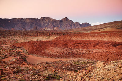 Scenic view of landscape at el teide national park against sky during sunset